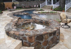 photo of rock-walled pool and spa