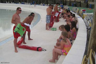 photo of pool lifeguards giving safety lessons to children
