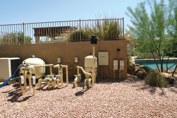 The equipment pad for the pool shown on the opener.