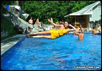 photo of woman diving sideways into pool