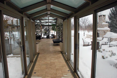 photo of glassed in corridor to the pool room