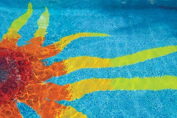 photo of sun design on bottom of swimming pool