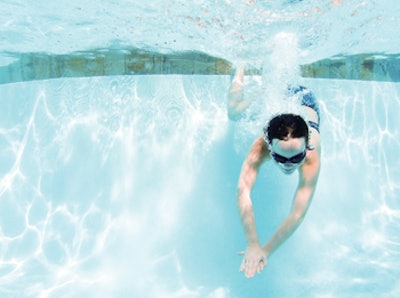 photo of girl diving underwater