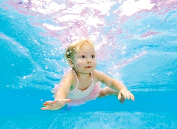 photo of girl swimming under water in a tutu