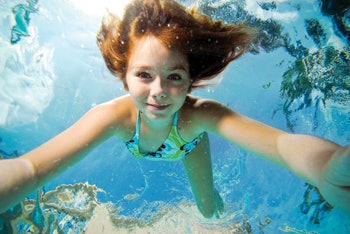 photo of girl swimming under water