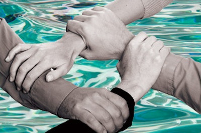 photo of four hands grabbing each other's wrists