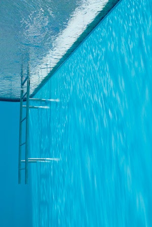 photo of underwater view of a pool ledge with a ladder
