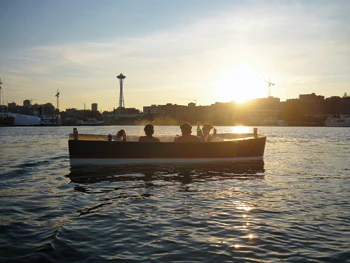 photo of group relaxing in a Hot Tub Boat at sunset