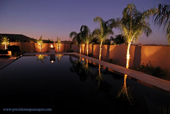 Image of pool at night with reflective lighting