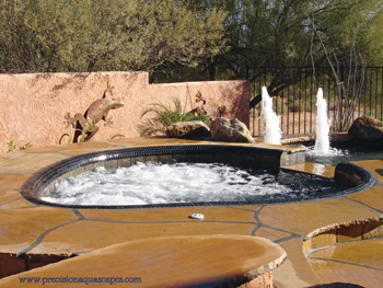 Image of outdoor hot tub with water fountains in background