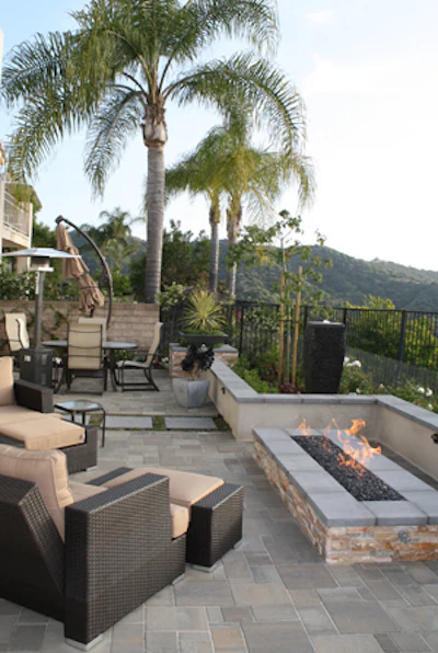 Fire pits can come in a wide range of shapes and sizes. Here a rectilinear pit blends seamlessly with the overall design scheme while providing an intimate setting for relaxation overlooking a beautiful hillside view. (Credit: OutdoorFireplaceDesignIdeas.com)
