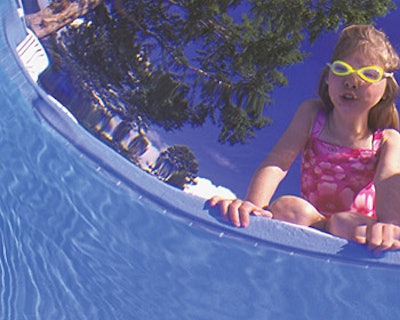 photo of little girl in swimsuit with swimming goggles
