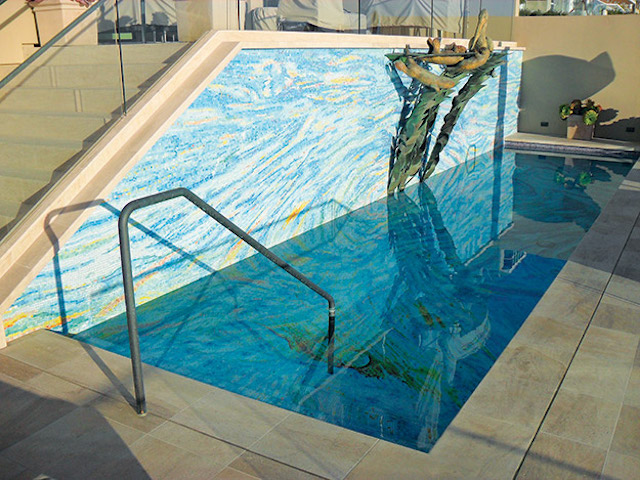 Not only does this pool feature an all-tile bottom, but the tile extends up the adjoining wall for a powerful effect. (Photos courtesy of Agape Tile.)