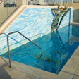 Not only does this pool feature an all-tile bottom, but the tile extends up the adjoining wall for a powerful effect. (Photos courtesy of Agape Tile.)