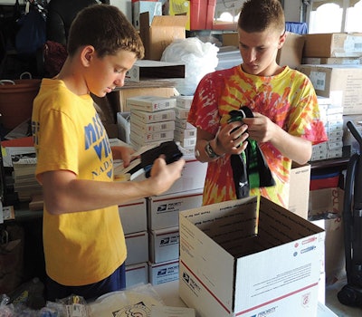 photo of children packing boxes of goggles