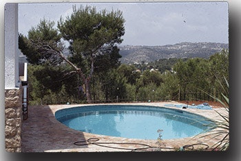 photo of a circular pool with a scenic background