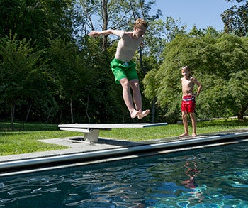 photo of kids jumping off of a diving board