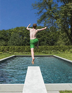 photo of a boy jumping off of a diving board