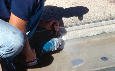 photo of a man sanding crystal formed in a swimming pool