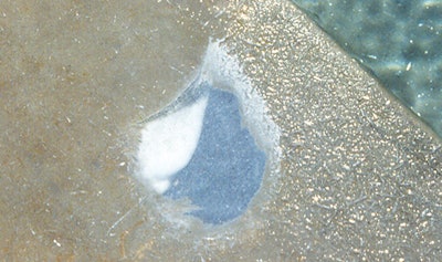 photo showing acid eating through crystals formed in a swimming pool