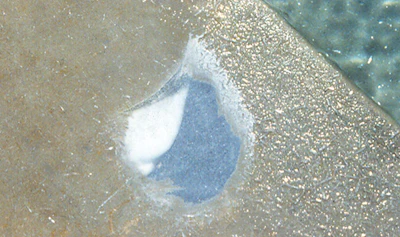 photo showing acid eating through crystals formed in a swimming pool