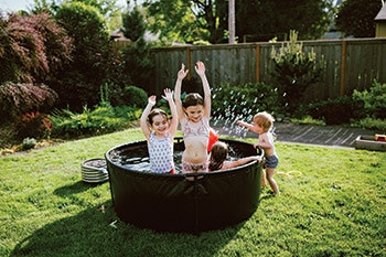 photo of children in a small backyard vinyl-sided hot tub