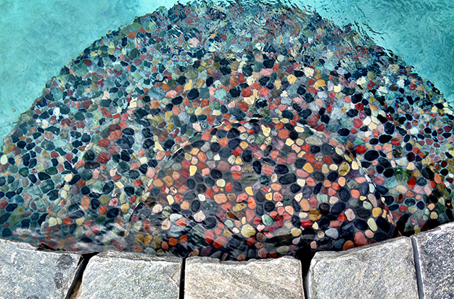 This set of wedding cake steps takes on the appearance of rock candy with its hand-laid stone mosaic finish. (Photos courtesy of Owens Pools & Spas)