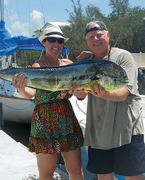 photo of two people holding a big fish