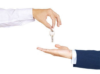 photo of someone giving someone else a set of keys