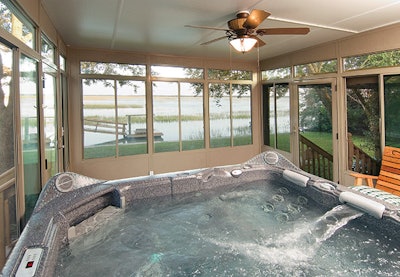 photo of a sunroom with a hot tub