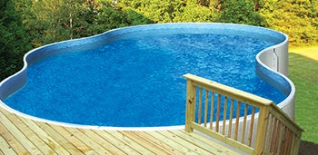 photo of an aboveground pool in a sloped backyard