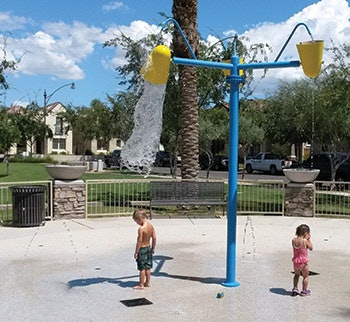 Two children playing at a splashpad