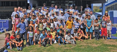 Lonza Dealer and employee volunteers pose with some of the children from the ESCUELA – Gil Tablada Corea elementary school in El Jobo, Costa Rica after a job well done.