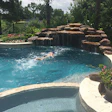 In this pool from Paragon Pools, water flows out of the grotto for both play and exercise. The current system is flush-mounted at the inlet and outlet with underground plumbing leading back to the pump.
