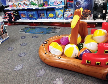 Campbell created hippo print adhesives that stick to the floor and lead kids directly to the toy section. - Click to enlarge