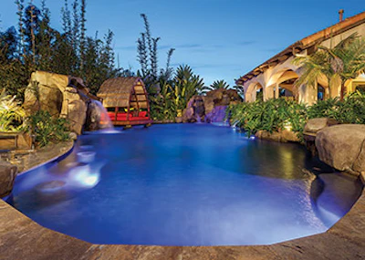 The pavilion in this Bali-style pool perches over the water on two rock pillars. - Click to enlarge