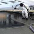 Worker applies waterproof coating to basin of reflecting pool water feature at the New York-New York Hotel and Casino in Las Vegas.
