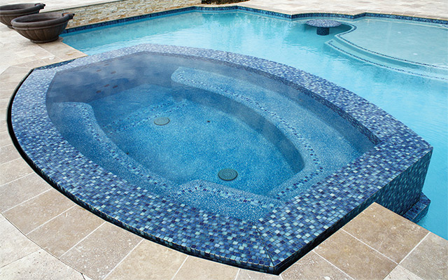 While portable spas are tough to beat when it comes to hydrotherapy and ergonomics, concrete spas can be designed and built to any shape and size, like this highly unusual spa that includes a trough lounger.