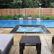 This vinyl-liner pool from Backyard Getaways was upgraded immensely by a drop-in spa with simple but gorgeous black stone coping.