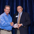 Robert Freligh accepts the award for most certified individuals to date from Fontaine Piper.