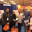 Ray Arouesty (center), John Oldfield (right of center) and guests at the IPSSA booth at the 2017 Pool & Spa Show.