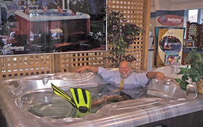 Jim Van Fleet, owner of Mainely Tubs, enjoys a relaxing dip in his showroom.