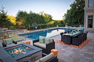 A firepit and outdoor dining adds flair to the outddoor recreational area.