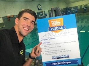 Michael Phelps signs the Pool Safely pledge.