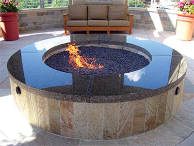 Even the simplest fire pits create beauty, nuance and a place togather. The reflective materials both capture the surrounding environment and at the same time, amplify the beauty of flame. (Photo courtesy of Grand Effects)