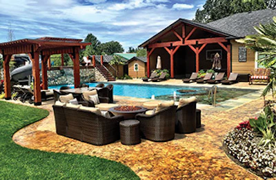 Fire pits can be used to create destinations and drive traffic patterns within the backyard. Here, designer/builder David Owens strategically located the pit area between the pool's tanning shelf and adjacent shade structure. (Photo courtesy of Owens Pools and Spas)