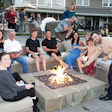 Fire pits are often the hub of social gatherings, as demonstrated by this inviting, contemporary-design pit and seating area, designed and installed by Scott Cohen. (Photo courtesy of The Green Scene Landscaping and Pools)