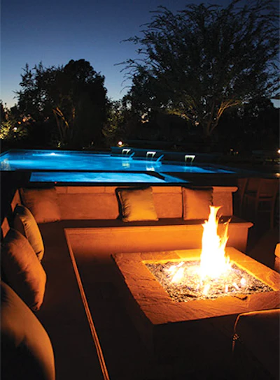 Fire features of all kinds bring the landscape to life after the sun goes down, especially when used with great architectural design and landscape lighting systems. (Photo courtesy of The Green Scene Landscaping and Pools)