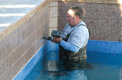 Working with vertical surfaces of raised bond beams, walls and associated water features means installers sometimes need to don hip waders to install cover anchors.