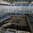 The Aquatic Stadium pool sits drained and abandoned.